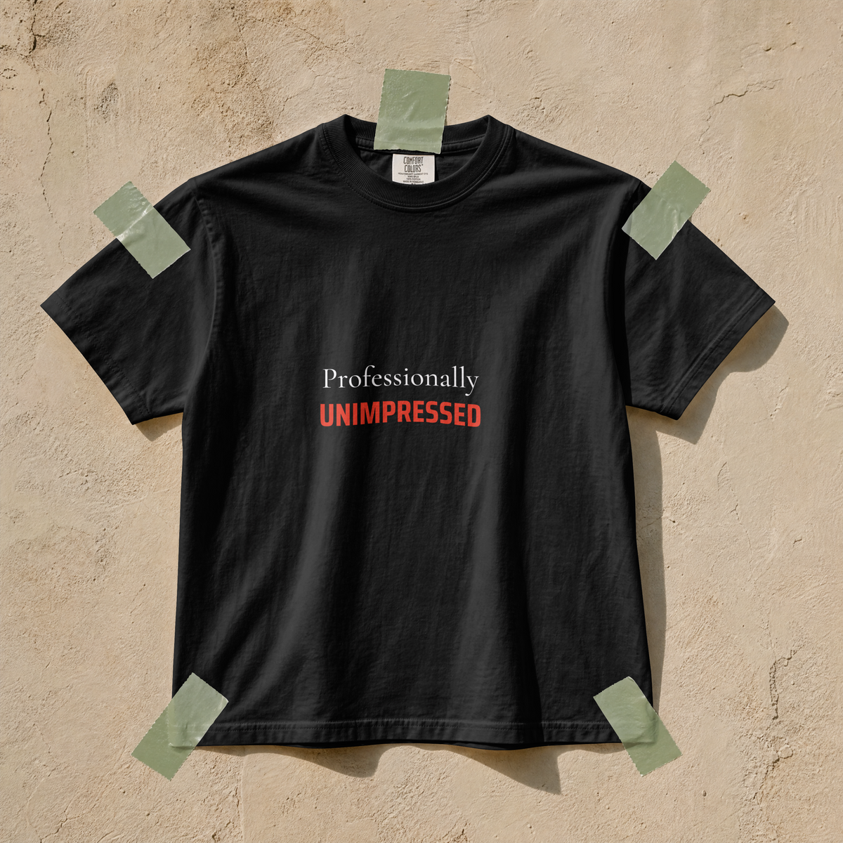 Close view of the Professionally Unimpressed slogan on garment-dyed cotton